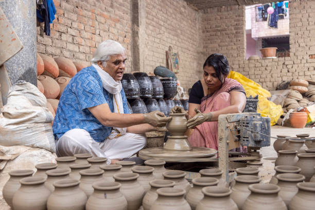 istock Father with daughter making clay pot on spinning wheel 1362713693