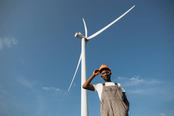 istock African american technician posing on field with windmills 1362713776