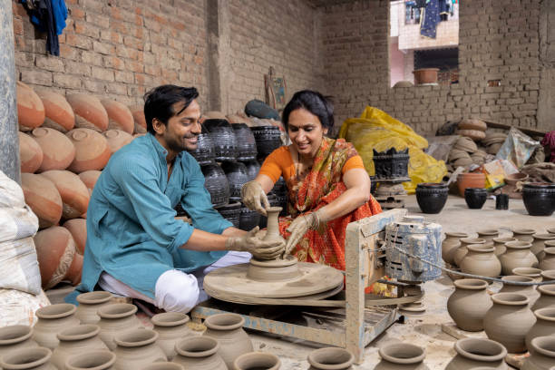 istock Couple making clay pot on spinning wheel 1362713901