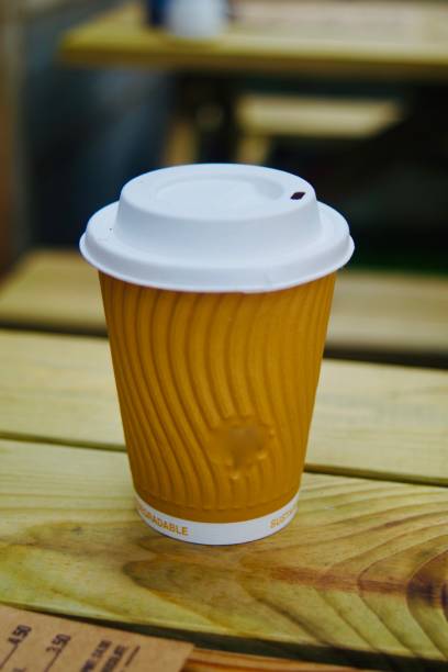 istock Hot drink in a recyclable cup on a wooden table 1362713902