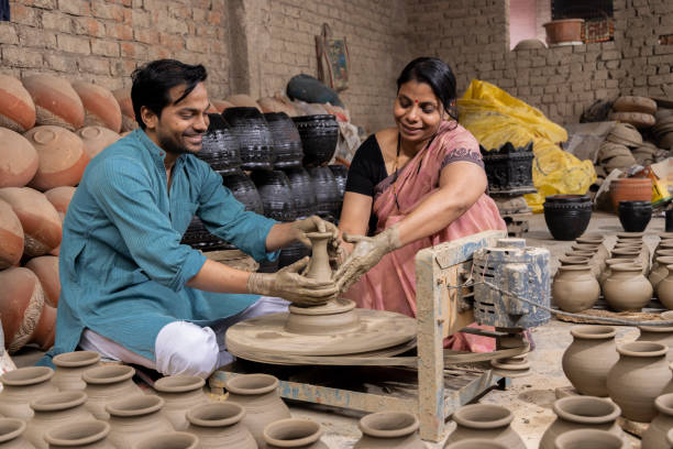 istock Couple making clay pot on spinning wheel 1362713959
