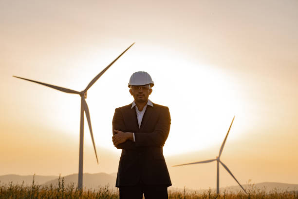 istock Indian man posing with crossed arms at windmill farm 1362714002