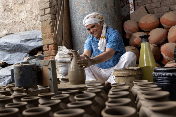 istock Man making clay pot on spinning wheel 1362714150