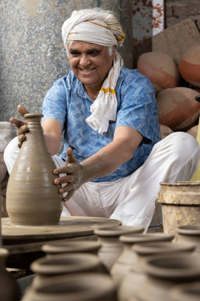 istock Man making clay pot on spinning wheel 1362714153
