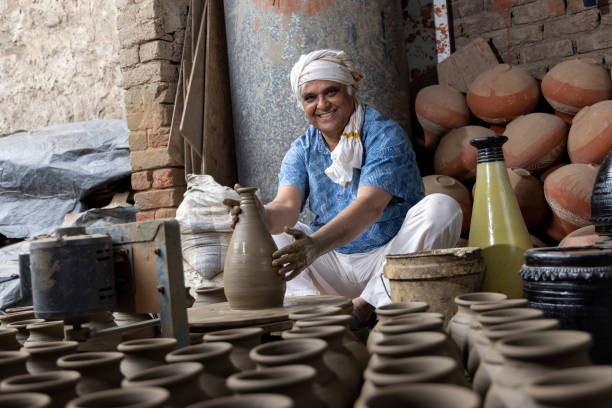 istock Man making clay pot on spinning wheel 1362714176