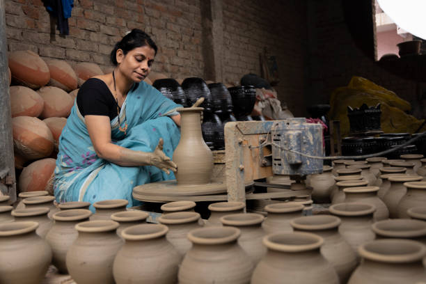 istock Woman making clay pot on spinning wheel 1362714712