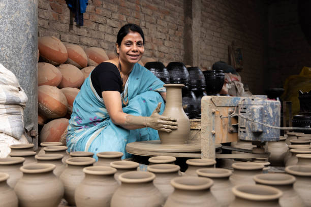 istock Woman making clay pot on spinning wheel 1362714714