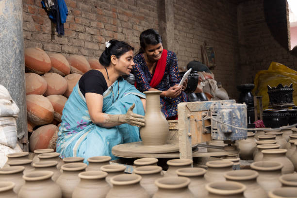 istock Mother and daughter using digital tablet at pottery workshop 1362715228