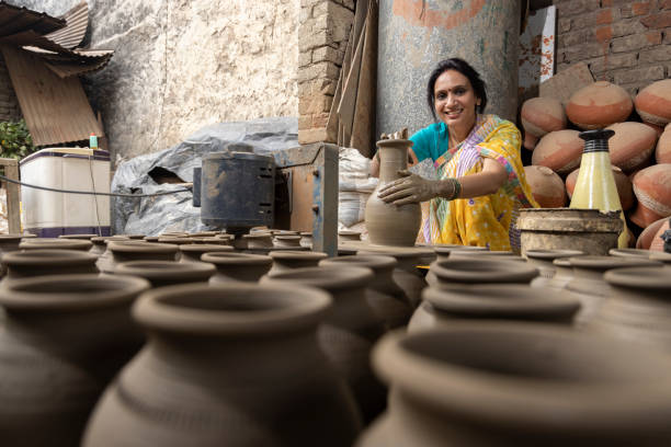 istock Woman making clay pot on spinning wheel 1362715229