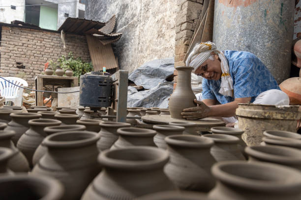 istock Man making clay pot on spinning wheel 1362715256