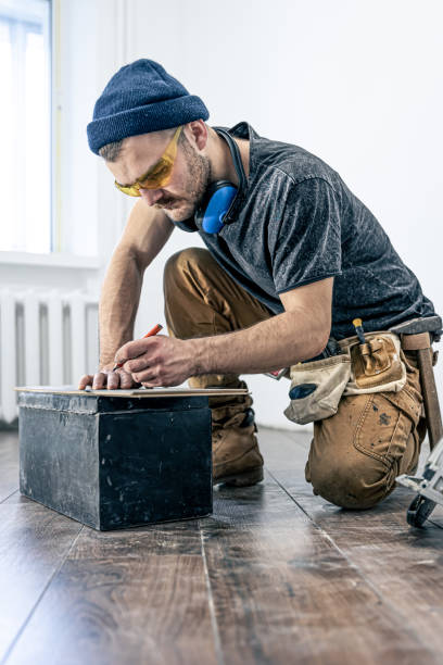 istock A male worker puts laminate flooring on the floor. 1362716030