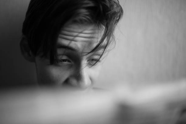 istock Young man reading a newspaper with emotions on his face 1362718830