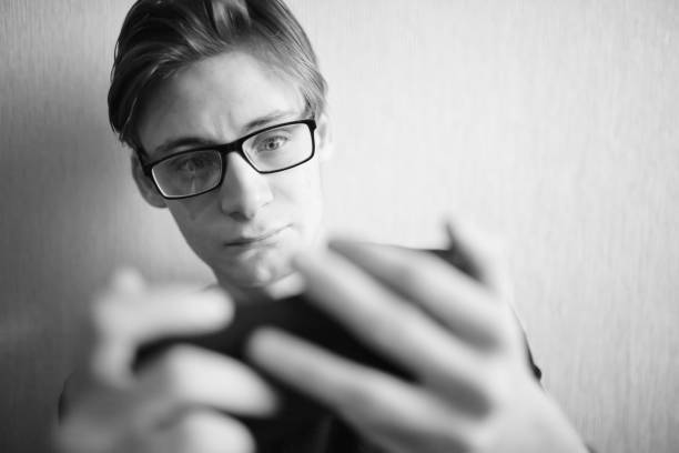 istock Young guy looks at smartphone and screams 1362718965