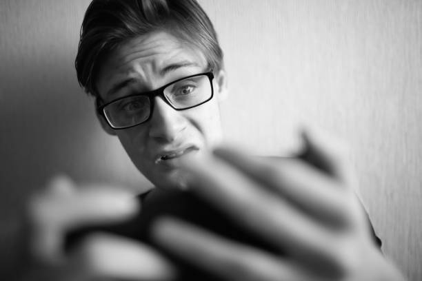 istock Young guy looks at smartphone and screams 1362718977