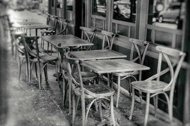 tables and chairs on the street - vintage black and white stock photo