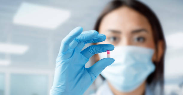 istock Young woman doctor holding a pill 1362720857