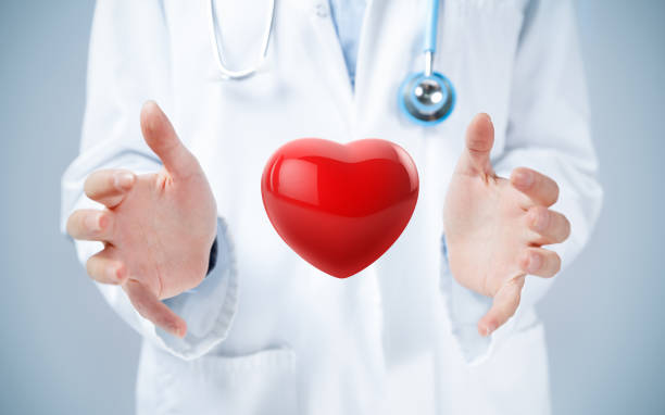 istock Female doctor hands around a red heart 1362721536