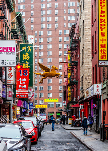 People strolling the narrow streets of Chinatown in New York City, USA