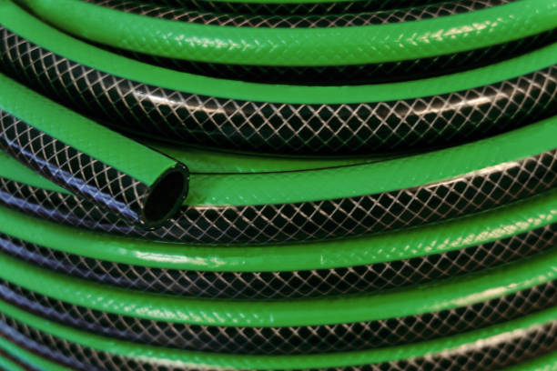 Rolled green garden hose close-up stock photo