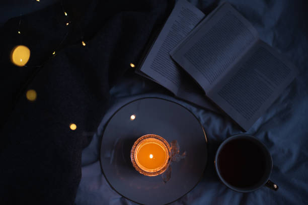 istock Cozy home atmosphere with candle and books 1362724422