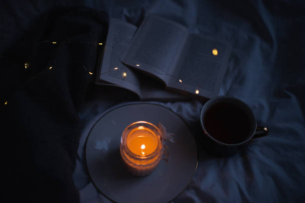 istock Cozy home atmosphere with candle and books 1362724474