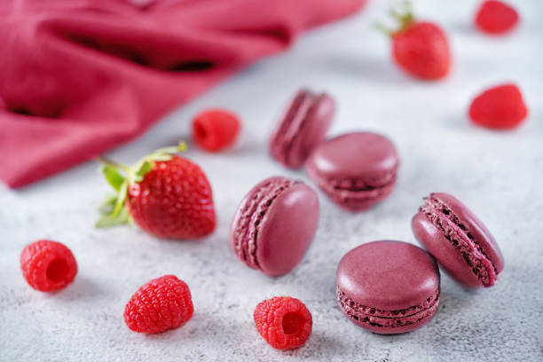 istock Berries macarons with cream filling and fresh strawberries and raspberries 1362724921