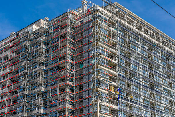istock Part of building exterior with scaffolding on it. Construction site, insulation process 1362728587