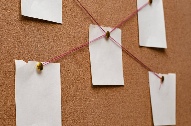 Blank paper notes are pinned to a cork board. The concept of detective investigation. Copy space. Blank paper notes are pinned to a cork board. The concept of detective investigation. Copy space detective wall stock pictures, royalty-free photos & images