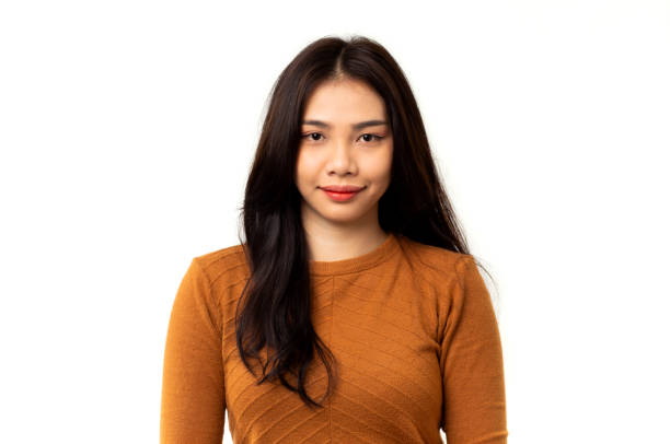 Portrait of Asian woman wearing an orange shirt on a white background. stock photo