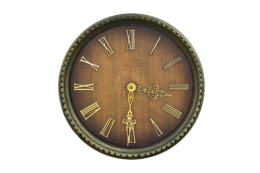 Antique wooden wall clock with Roman numerals, time concept