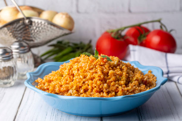 Traditional turkish bulgur pilaf with tomato sause in plate (Turkish name; meyhane pilavi) Traditional turkish bulgur pilaf with tomato sause in plate (Turkish name; meyhane pilavi) bulgur wheat stock pictures, royalty-free photos & images