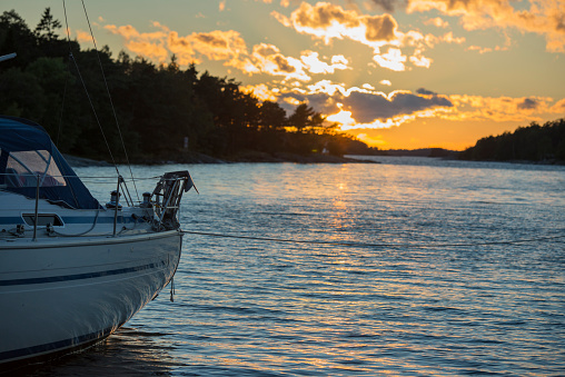 Sunset in the archipelago with a moored sailboat