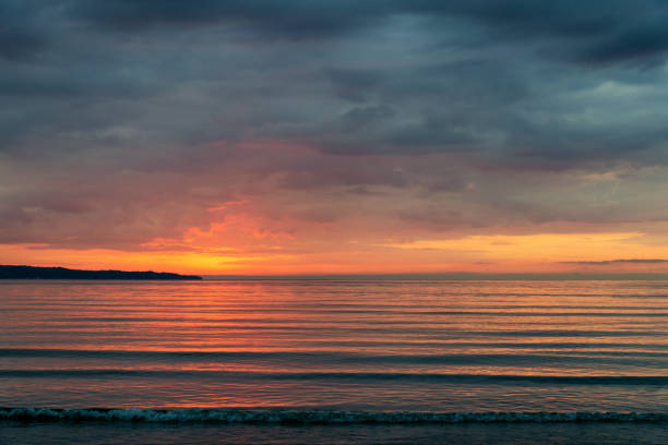 istock beautiful fiery sunrise on the beach - space for text 1362731852
