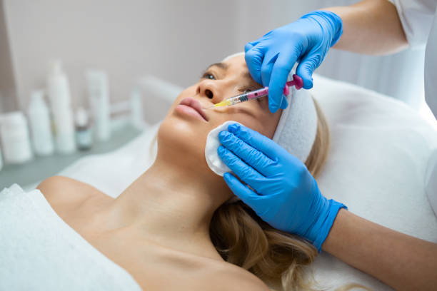 istock Lip augmentation procedure. Woman getting beauty injection for lips 1362733004