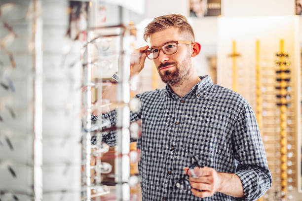 istock Young man buying eyelasses at the optical store 1362736202
