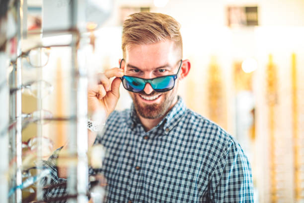 istock Young man buying eyelasses at the optical store 1362736250