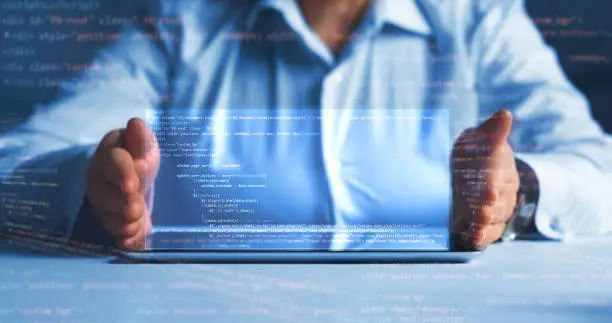 Photo of Programming code technology.Software apps developer and IT revolution.Digital software development. Programmer working on javascript computer code with virtual screen.