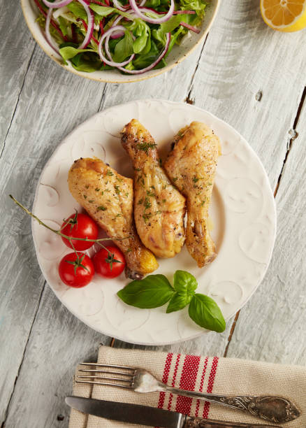 istock Baked chicken legs and salad 1362738932