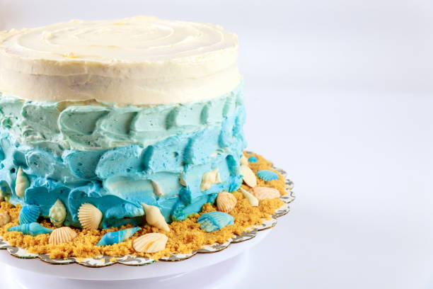 Marine cake decorated with blue cream and seashells.