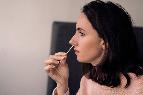 istock Woman holding self-testing swab and rapid test for Coronavirus/COVID-19 1362741934