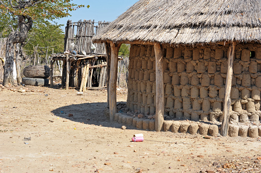 Unusual construction of mud hut in tribal village on the road between Victoria falls and Hwange National Park, western Zimbabwe, Southern Africa. Much of landlocked Zimbabwe remains undeveloped and a mix of bush with semi-fertile land with scattered forests that each occupy approx 40% of land mass. The Zambezi river forms a natural boundary with Zambia with the massive Victoria Falls forming the world's largest curtain of falling water.