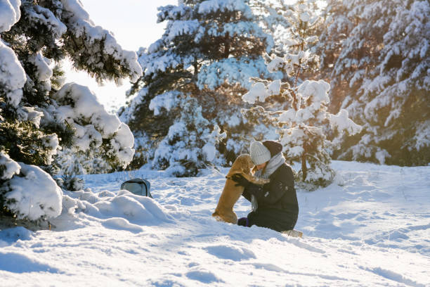 istock Woman with cocker spaniel in the winter forest. 1362745370