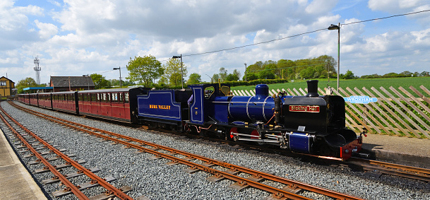 Wroxham, Norfolk, England - May 11, 2018:  Blickling Hall Narrow Gauge Steam Train at Wroxham Station on the Bure Valley Railway Norfolk.