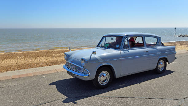 Felixstowe, Suffolk, England - May 06, 2018:  Classic Grey Ford Anglia  Car being driven along Seafront  Promenade.