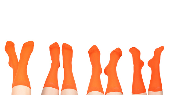 Orange socks on woman foot isolated on white background.