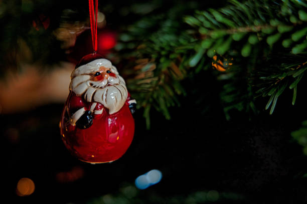 istock cute santa claus is hanging on a christmas tree 1362747929