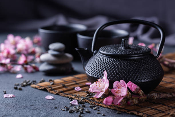istock Teapot and tea cups with blooming almond tree branches 1362749459
