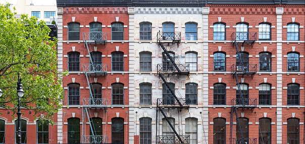 Block of old apartment buildings with windows and fire escapes in the Tribeca neighborhood of New York City NYC