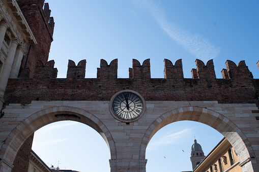 Verona city wall with a clock