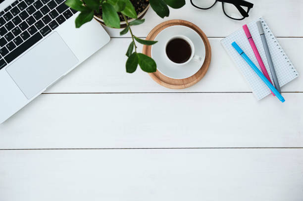 istock Flat lay of office desk work space table with computer wireless keyboard and stationary in home office on white wood table. Copy space for add text or graphic. 1362755121